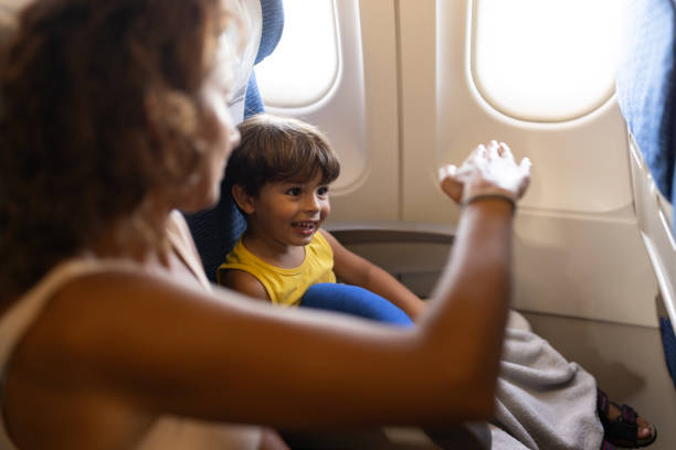 Woman and her little having fun together during a flight.