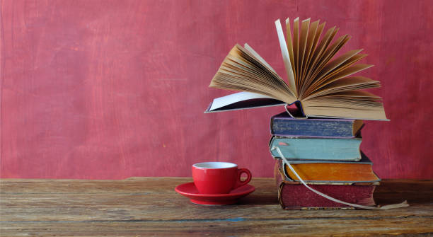 istock Stack of books with open book and cup of espresso coffee, reading, learning, knowledge is power,education or home office concept 2057857390