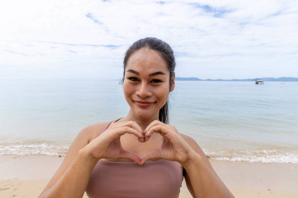 istock Heartfelt Harmony: Thai Woman Embodies Tranquility in Beachside Yoga Pose 2057862278