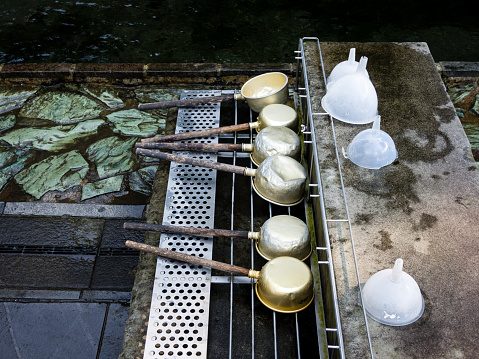 Ladles for scooping water at Shirakawa Springs, famous for its water quality - in Minamiaso village, Kumamoto prefecture, Japan