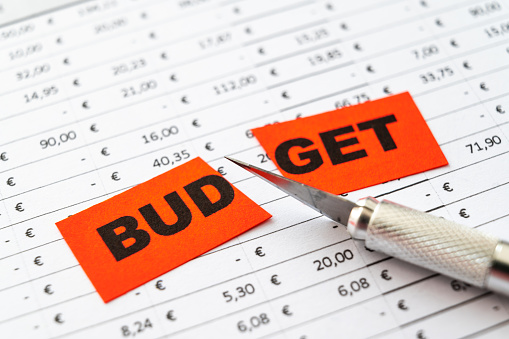 Table with budget, expenses, revenues and ticket with Budegt text cut in two. Budget cut.