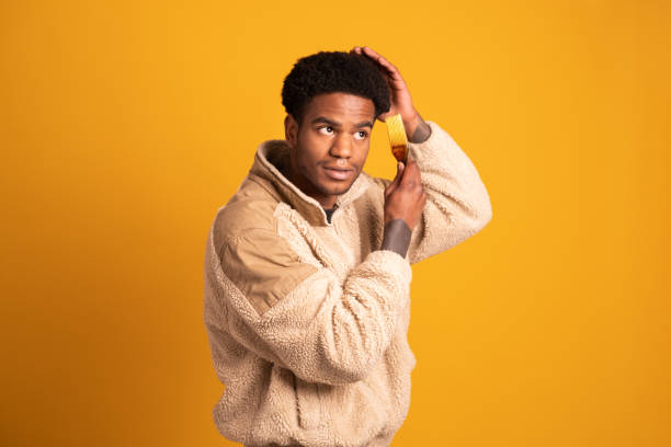 istock African man using brush to comb his curly hair 2057885238