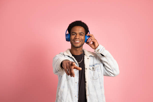 istock African man pointing ahead while listening to music 2057885792
