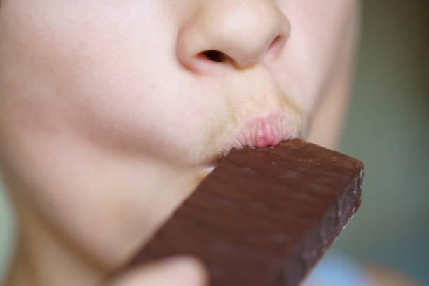 istock Crop unrecognizable girl eating delicious chocolate protein bar 2057889610