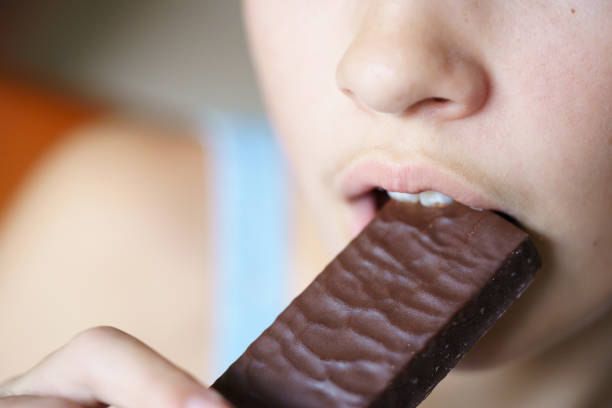 istock Crop anonymous teenage girl biting nutritious protein bar 2057890023
