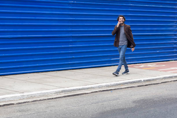 istock View of a young man with  smartphone walking 2057895409