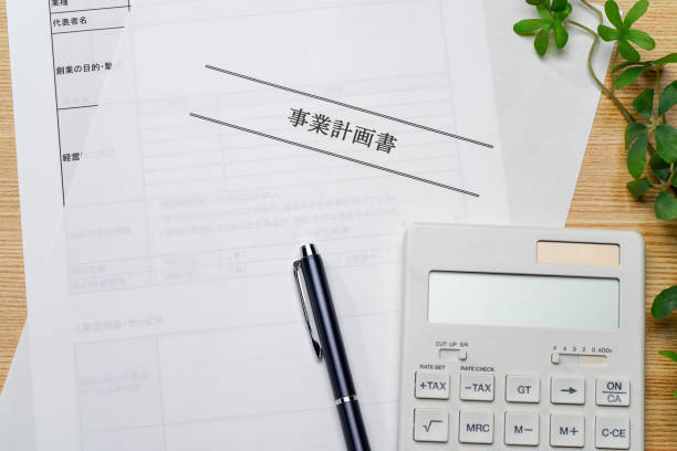 Business plan, pen and calculator on wooden table