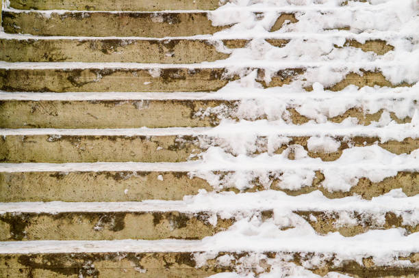 The stairs are covered in snow and ice. The image has a cold and wintry mood