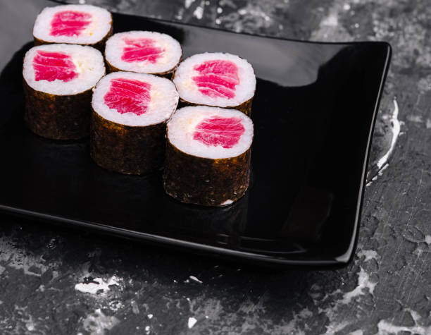 istock Tuna Maki Sushi on Black Stone Plate 2057923144