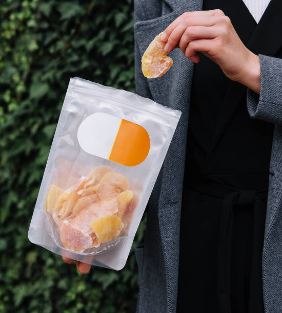 istock Girl Eating Dried Mango Slices 2057923151