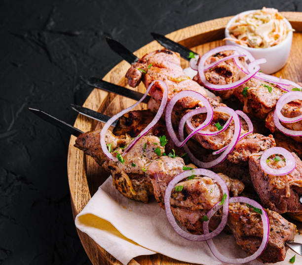 istock kebabs from pork on skewers on wooden board 2057930194