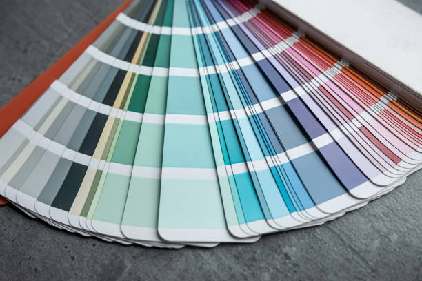 istock Rainbow catalog of paints with a various color palette on grey desk 2057942197
