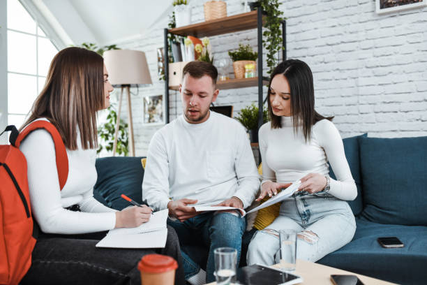 istock Male Student Asking Female Classmates To Explain Certain Concepts While Studying At Home 2057944383