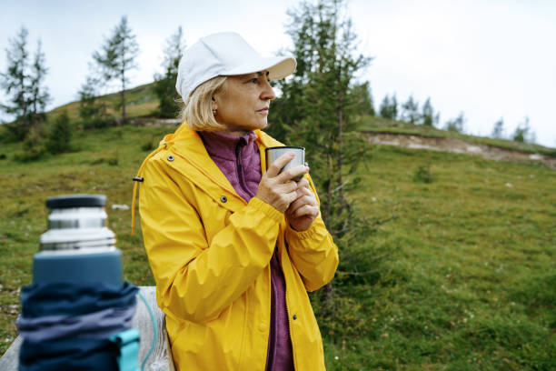 istock Senior woman drinking tea on mountains 2057949361