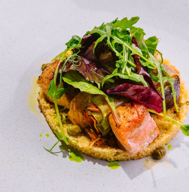 istock fried salmon with cous cous and arugula 2057954710