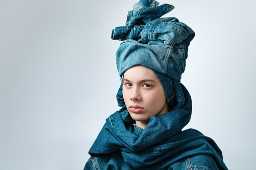 Portrait of a girl wearing a turban-like denim headdress. Jeans clothes, total denim.