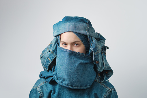 Portrait of a girl wearing a turban-like denim headdress. Jeans clothes, total denim.