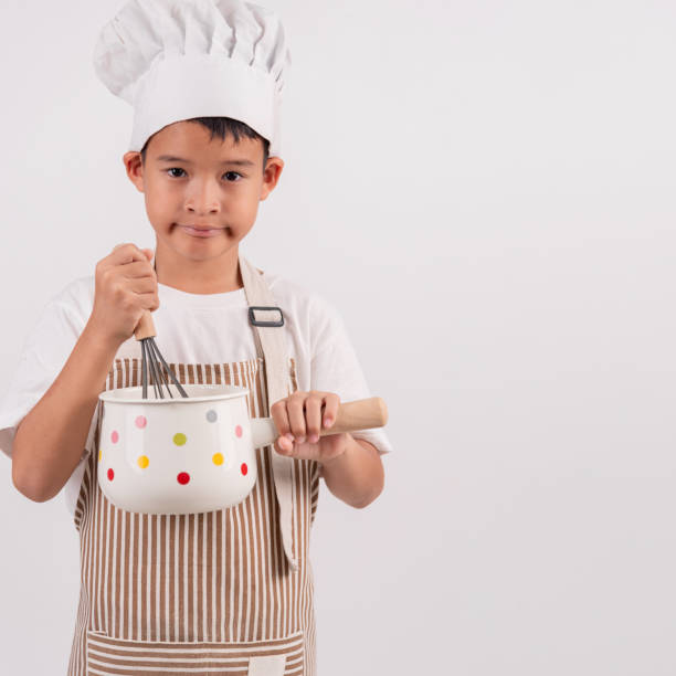 istock Little cute asian boy cooking on white background. 2057983912