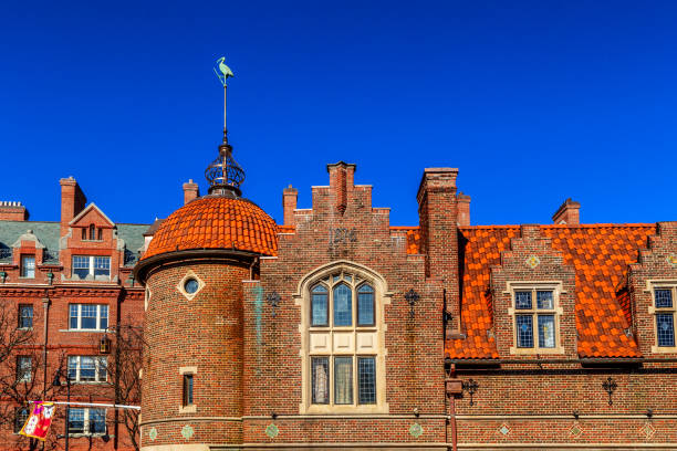 Cambridge, Massachusetts, USA - March 1, 2024: The Harvard Lampoon building (sometimes referred to as the Lampoon Castle) is a historic building in Cambridge, which is best known as the home of The Harvard Lampoon. The building was constructed at 44 Bow Street not far from Harvard Yard. Designed by Edmund M. Wheelwright, it was first opened in 1909. Wheelwright had attended Harvard University and was one of the founders of the Harvard Lampoon. The Harvard Lampoon publication was founded in 1876 by seven undergraduates at Harvard University who were inspired by popular magazines like Punch (1841) and Puck (1871). The Harvard Lampoon is the world's third longest-running continually published humor magazine. The building was added to the National Register of Historic Places in 1978. Side view of the building.