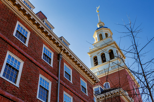 Cambridge, Massachusetts, USA - March 1, 2024: View of the the Lowell House bell tower and cupola. Lowell House is one of twelve undergraduate residential Houses at Harvard University, located on Holyoke Place. Named for the prominent Lowell family, closely identified with Harvard since John Lowell graduated in 1721. Built in 1930 and of neo-Georgian design.
