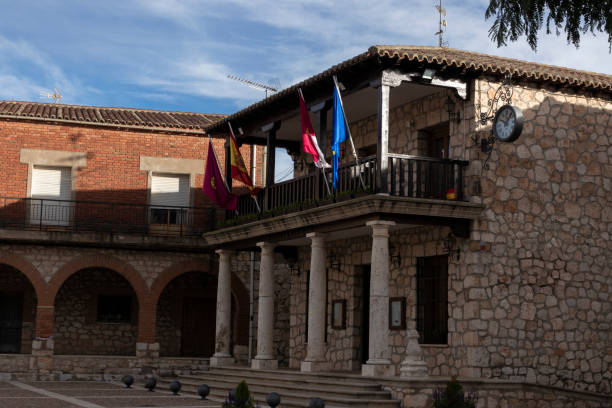 istock a stone building with arches, flags, a clock, and a balcony under a partly cloudy sky 2058018333