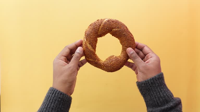 top view of hand holding Turkish Bagel Simit