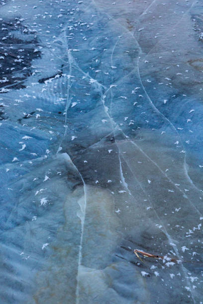 istock A beautiful cracked ice patterns on the frozen lake surface during winter in Latva. 2058063369