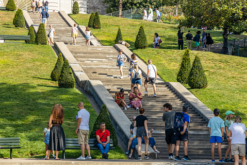 Paris, France - September 10, 2023 : Tourists on the stairs of Square Louise Michel in Montmartre in Paris on a summer day