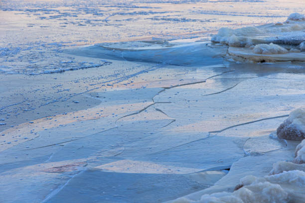 A beautiful cracked ice patterns on the frozen lake surface during winter in Latva. Cold scenery of Northern Europe.