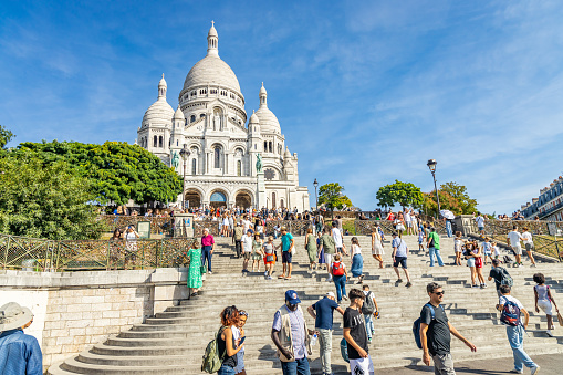 Paris, France - September 10, 2023 : Tourists and the Basilica of the Sacred Heart in Montmartre in Paris, France