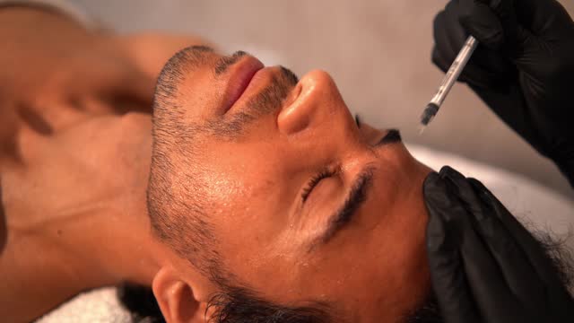 Man lying during a facial beauty treatment with facial peeling