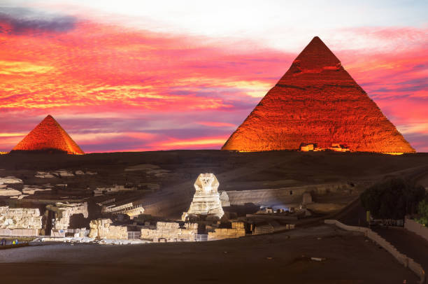 istock Illuminated Pyramids of Egypt and the great Sphinx night view, Giza 2058083679