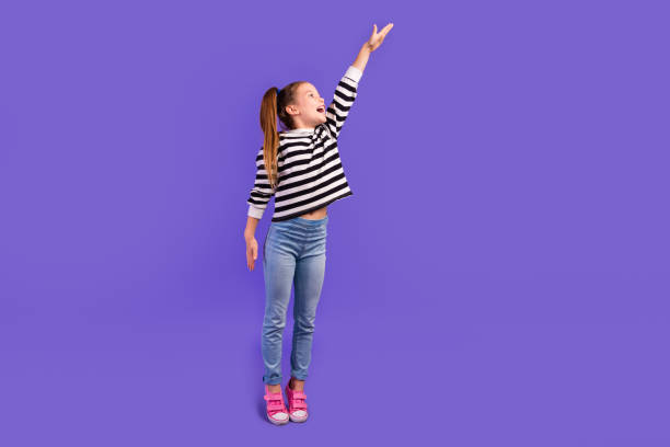 istock Full length photo of funky impressed little child dressed striped pullover showing arm empty space isolated purple color background 2058090683