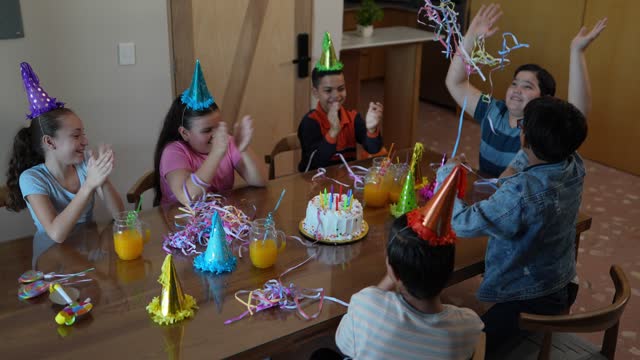 Children celebrating a birthday at home