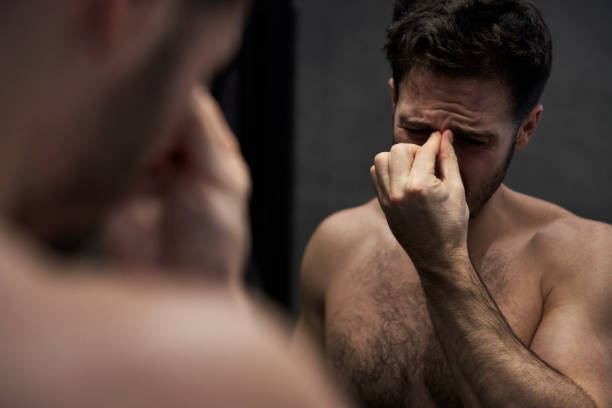istock Man having headache in the bathroom 2058096669