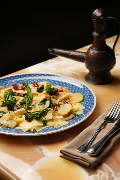 istock Vegetarian pasta with broccoli potato and tomatoes 2058131745