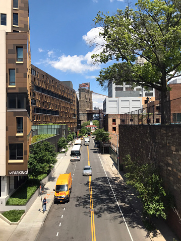05 June, 2023 - United States, New York, Brooklyn - Fulton Ferry - Manhattan Bridge view from the side street with cars on the road.
