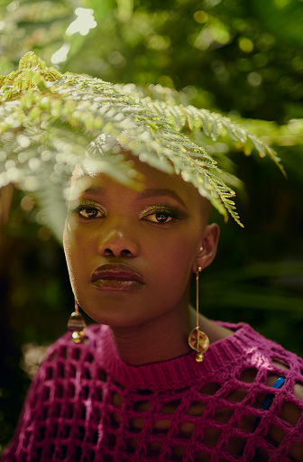 Portrait of a beautiful African woman in a lush garden