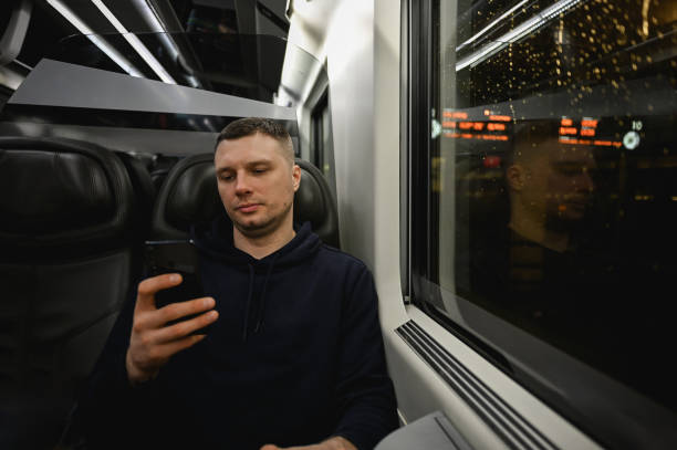 istock Portrait of a handsome man scrolling mobile phone during his trip by train. 2058159145