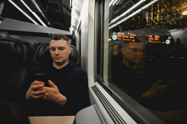 istock Mid adult businessman using mobile phone in a luxury train. 2058159694