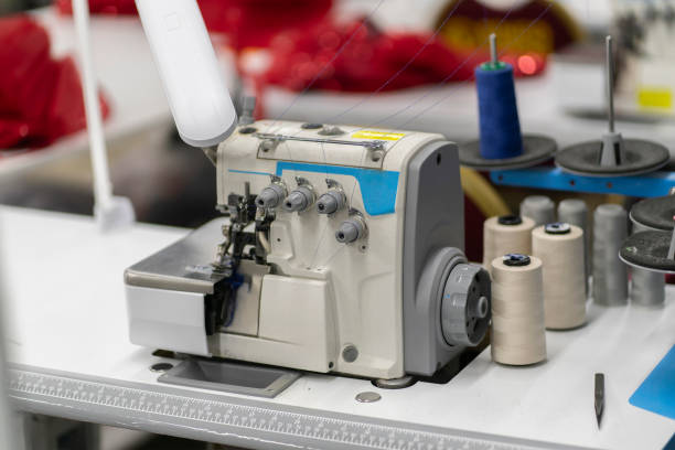 istock the overlock. automatic sewing machine on the textile production factory 2058171996