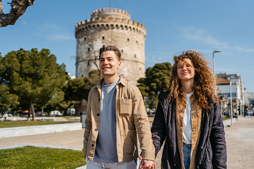 Young couple walking in the park in Thessaloniki, Greece.