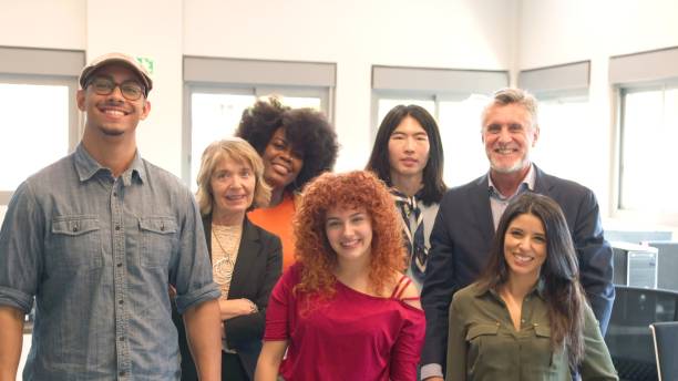 istock group of smiling multiracial office mates looking at the camera 2058213553