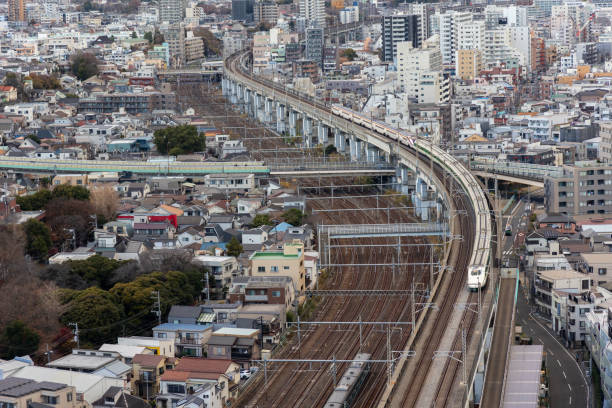 Tokyo, Japan - December 22, 2023 :  E2 and E3 Shinkansen bullet trains travel along an elevated railway track in Tokyo, Japan.