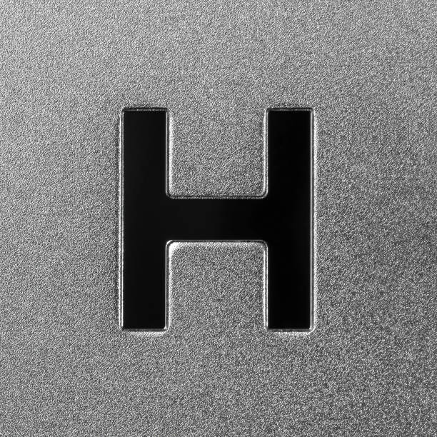 Letter H on a silver grained shiny metal surface. English alphabet. Element for design.