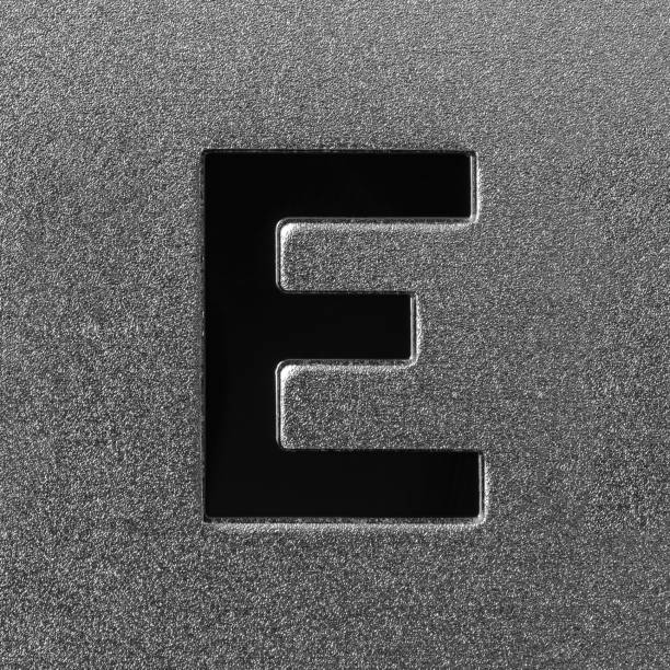Letter E on a silver grained shiny metal surface. English alphabet. Element for design.