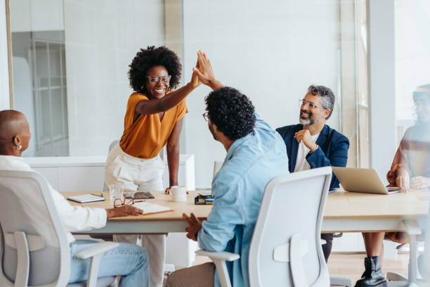 istock Successful business team celebrating a project in a boardroom 2058234140