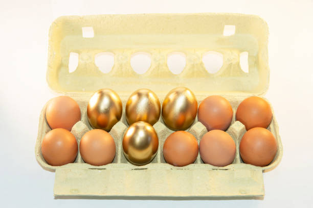 Cardboard paper tray with brown and gold eggs. Pack with decorative dyed eggs for Easter. Price increase of eggs.Preparation for the holiday