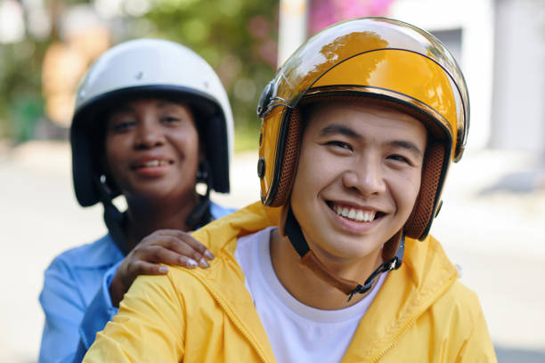 Motorbike Driver and Happy Passenger Portrait of smiling Vietnamese motorbike driver and happy passenger vietnamese man taxi motorbike driver stock pictures, royalty-free photos & images