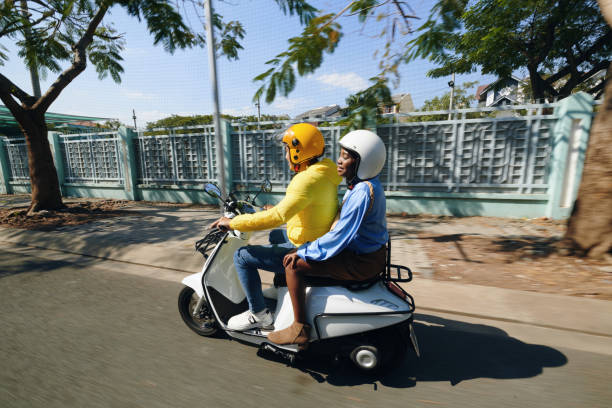 Motorbike Taxi Ride Motorbike taxi driver riding with passenger vietnamese man taxi motorbike driver stock pictures, royalty-free photos & images
